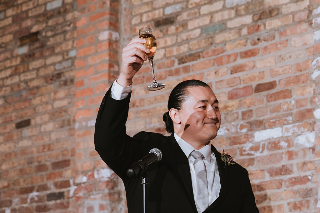 ask the audience to raise a glass to the newlyweds or to join you in a toast.