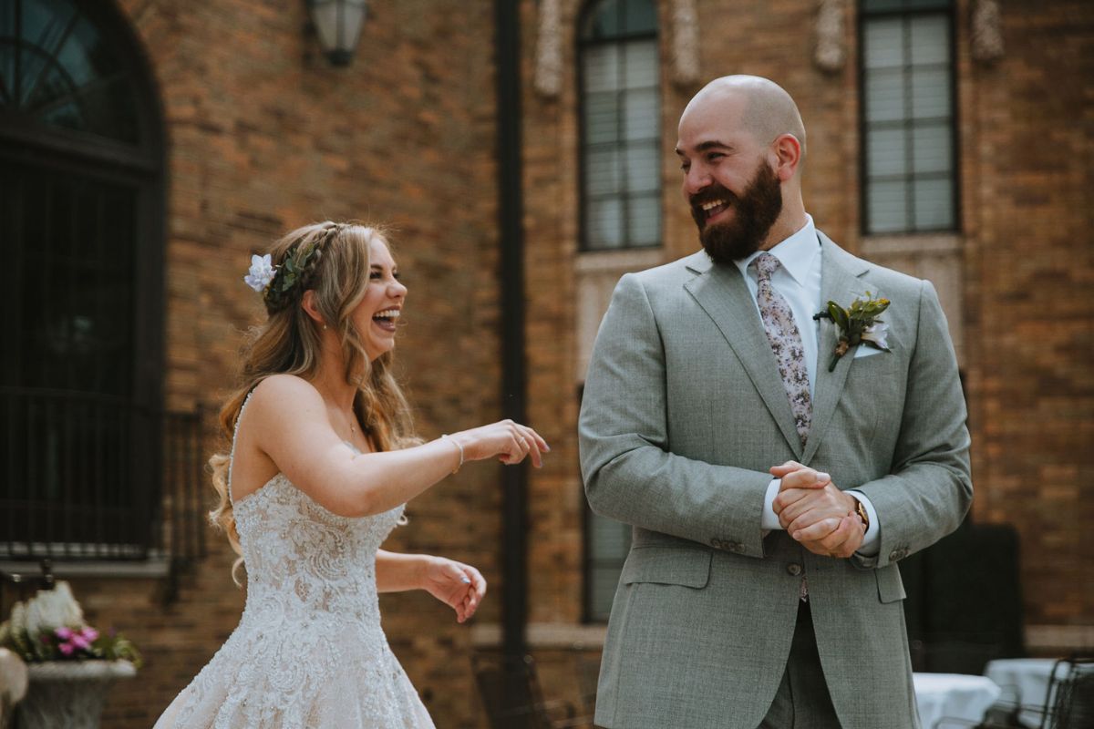 Bride and groom laughing together during their wedding celebration