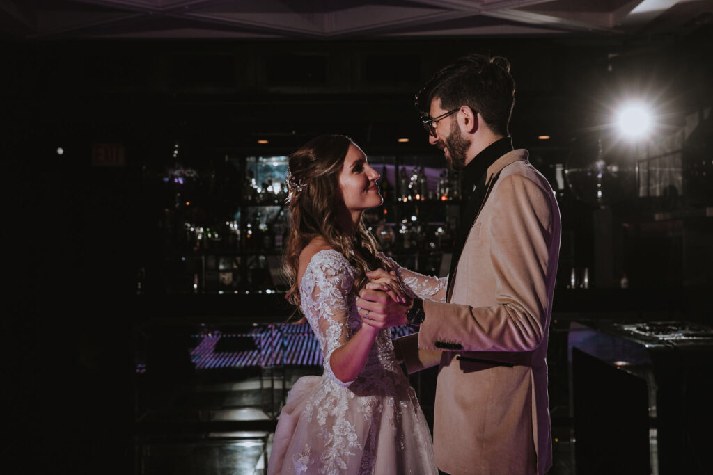 Bride and groom sharing a joyful moment while dancing together.
